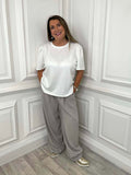 Beige wide leg trousers with relaxed fit styled with white puff sleeve top and sneakers for modern womens fashion everyday. - Malissa J Wide Leg Trousers - Stone