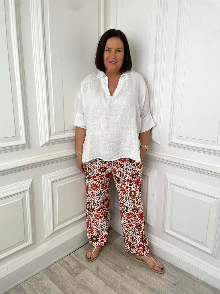Womens fashion floral tile print trousers in relaxed fit paired with white blouse for modern everyday wear. - Floral Tile Print Trousers