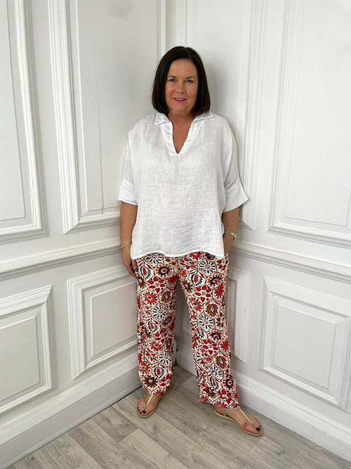 Womens fashion floral tile print trousers in relaxed fit paired with white blouse for modern everyday wear. - Floral Tile Print Trousers