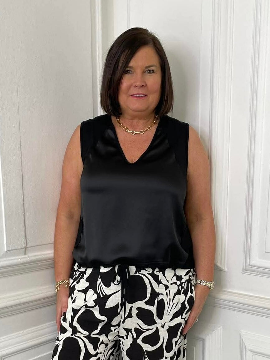 Black silk-feel drawstring vest paired with patterned trousers for relaxed, modern womens fashion everyday wear. - Malissa J Silk Feel Drawstring Vest - Black
