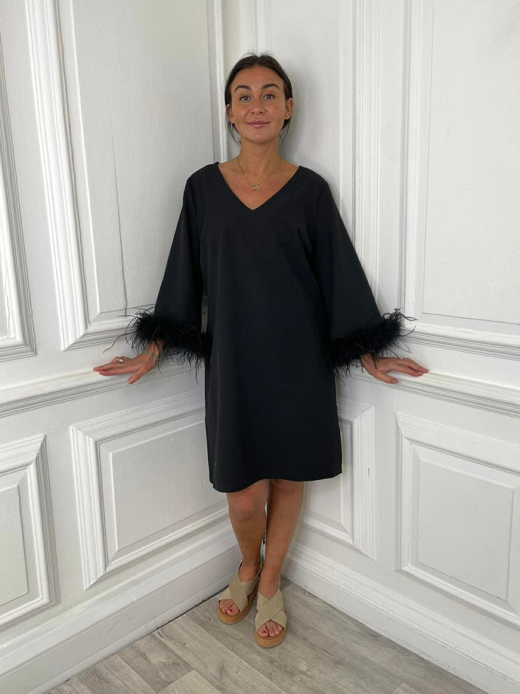 Black feather-trimmed dress with V-neck and loose sleeves, relaxed styling for modern womens fashion and everyday wear. - Malissa J Rio Feather Dress - Black
