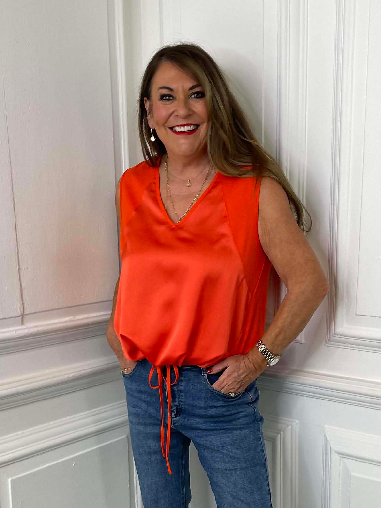 Orange silk-feel sleeveless drawstring vest paired with jeans for relaxed womens fashion and everyday wear. - Malissa J Silk Feel Drawstring Vest - Orange