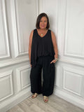 Black wide curved hem trousers paired for womens fashion with a sleeveless loose black top, relaxed styling for everyday. - Wide Curved Hem Trousers - Black