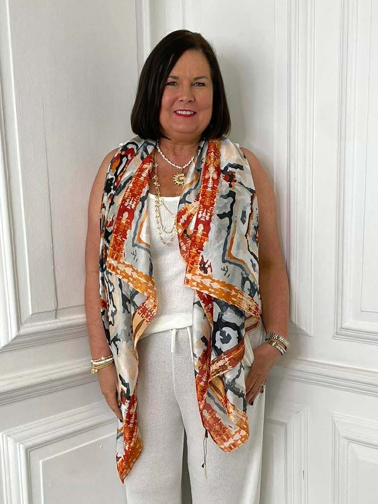 Orange Malissa J Kaleidoscope scarf with bold abstract print styled over white top and pants for relaxed, modern womens. - Malissa J Kaleidoscope Scarf - Orange