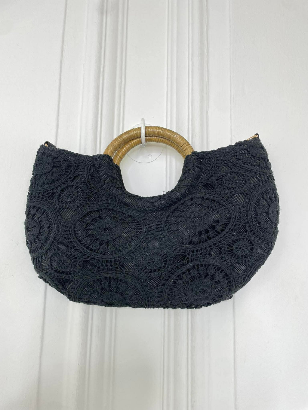 Black crochet handbag with circular wooden handles, featuring intricate textured pattern for relaxed styling and everyday. - Crochet Bag - Black